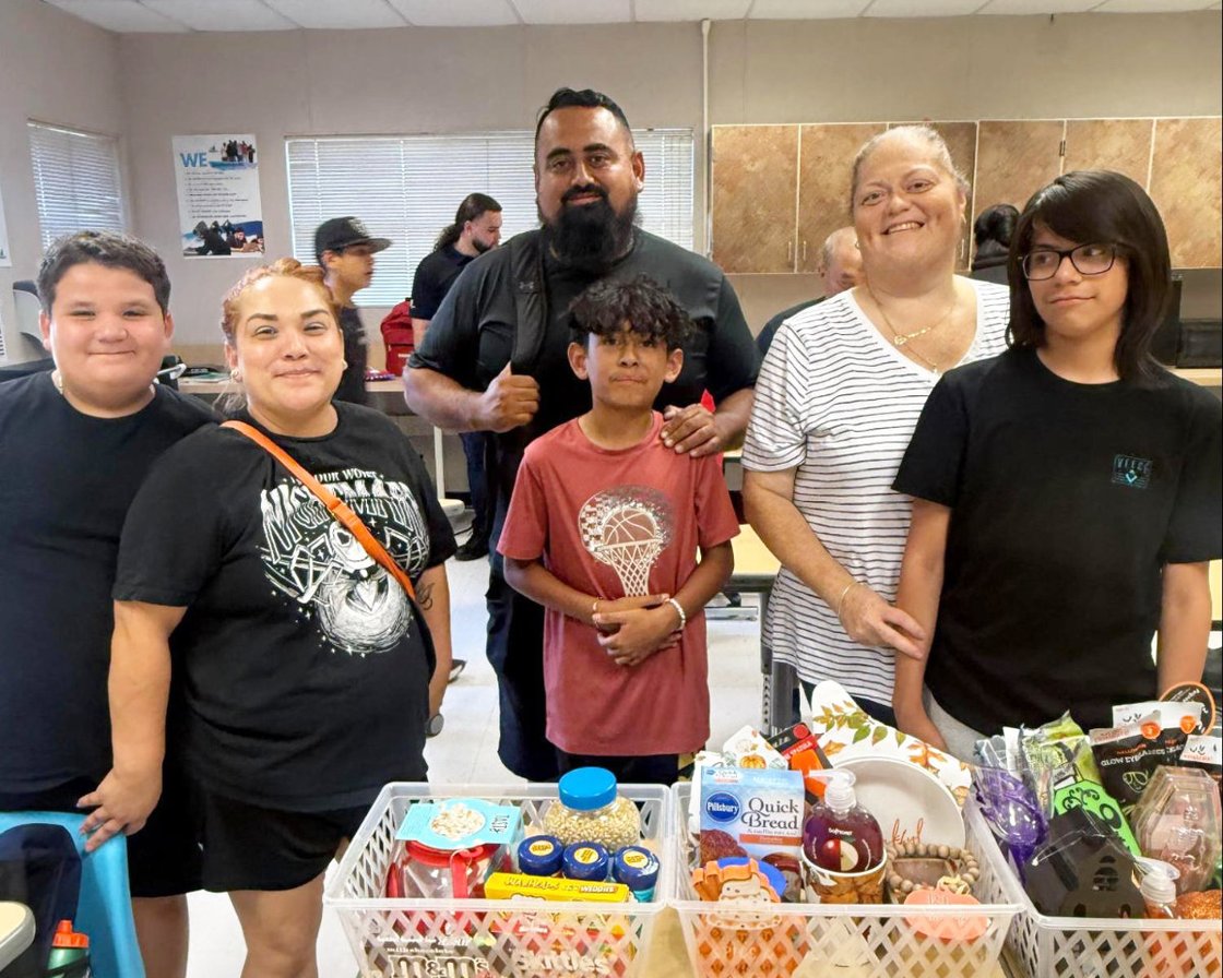 Raffle prize winners Jesse, Josiah, and Fernando proudly show off their prizes